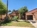 Beautiful one-story home with stone accents, arched entryway, and an attached two-car garage in a well-kept front yard at 11233 W Olive Dr, Avondale, AZ 85392