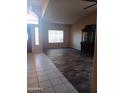 Bright living room with decorative flooring and a large window to let in natural light at 11233 W Olive Dr, Avondale, AZ 85392