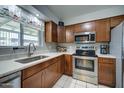 Updated kitchen featuring wood cabinets, stainless steel appliances, light countertops and a window at 1740 W Crescent Ave, Mesa, AZ 85202