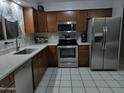 Well-equipped kitchen with stainless steel appliances, shaker cabinets, and white countertops at 1740 W Crescent Ave, Mesa, AZ 85202