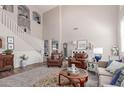 Elegant living room with high ceilings, wood flooring, and stylish decor, perfect for entertaining at 17538 W Marshall Ln, Surprise, AZ 85388