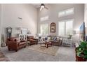 Bright and airy living room with plush seating, high ceilings, and lots of natural light from large windows at 17538 W Marshall Ln, Surprise, AZ 85388