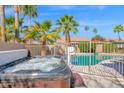 Relaxing backyard with a hot tub, pool, and mature palm trees creating a private retreat at 18014 N 53Rd Pl, Scottsdale, AZ 85254