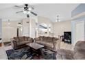 Open-concept living room with vaulted ceilings, tile flooring, ceiling fan, and an expansive seating area at 1836 N Stapley Dr # 4, Mesa, AZ 85203
