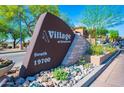 Community sign for Village at Grayhawk South with address and beautiful stone accents at 19700 N 76Th St # 2001, Scottsdale, AZ 85255