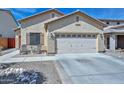 Lovely single-level home with a two-car garage and inviting seating area at the entrance, complemented by rock landscaping at 20338 N 262Nd Ave, Buckeye, AZ 85396