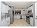 Modern kitchen with stainless steel appliances, granite countertops, stylish backsplash, and ample cabinet space at 20338 N 262Nd Ave, Buckeye, AZ 85396