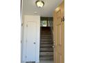Open entryway view of condo with wooden staircase and white closet doors at 225 N Pomeroy -- # 16, Mesa, AZ 85201
