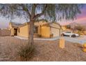 Charming single-story home with a two-car garage and easy to care for desert landscaping at 23932 W Hidalgo Ave, Buckeye, AZ 85326