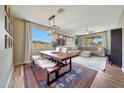 Bright dining area featuring a large window, wooden table with bench seating, and stylish decor at 2850 N 152Nd Ln, Goodyear, AZ 85395