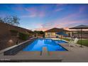 An inviting backyard pool and spa offer the perfect setting for relaxation and entertaining with lush landscaping at 31106 N 130Th Ln, Peoria, AZ 85383