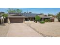 Well-maintained home with solar panels, offering energy efficiency and curb appeal at 3830 E Desert Cove Ave, Phoenix, AZ 85028