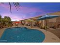 Inviting backyard with a sparkling pool and covered patio, perfect for outdoor relaxation and entertaining at 43261 W Neely Dr, Maricopa, AZ 85138