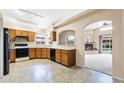 Functional kitchen with light countertops, wood cabinetry, tile flooring, and an open layout at 450 E Duke Dr, Casa Grande, AZ 85122