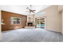 Spacious living room features vaulted ceiling, fireplace, plush carpet, and sliding glass doors to the pool at 450 E Duke Dr, Casa Grande, AZ 85122