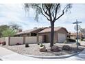 Well-maintained single story home with a two-car garage and low-maintenance desert landscaping on a corner lot at 5013 E Shomi St, Phoenix, AZ 85044