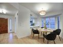 Cozy dining area with stylish lighting and views of the kitchen with window shutters allowing natural light at 614 W Kings Ave, Phoenix, AZ 85023