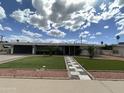 Charming home featuring a landscaped front yard and inviting walkway at 6207 W Orange Dr, Glendale, AZ 85301