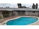 Sparkling private pool with ample patio space, surrounded by a secure fence at 6207 W Orange Dr, Glendale, AZ 85301