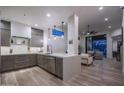 Open-concept kitchen with eat-in bar, stainless appliances, and access to the living area at 6703 E Soaring Eagle Way, Scottsdale, AZ 85266