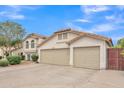 Exterior view of the home showing its three-car garage and nicely maintained landscaping at 844 E San Remo Ave, Gilbert, AZ 85234