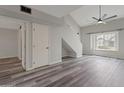 Spacious living room with high ceilings, gray plank flooring, and natural light at 860 N Mcqueen Rd # 1184, Chandler, AZ 85225