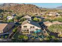 Aerial view of backyard featuring a covered patio, pool, lush landscaping, and privacy walls at 9443 E Mallory St, Mesa, AZ 85207