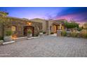 Beautiful exterior of a home with a stone accent wall and a paved driveway at 9643 E Legacy Ridge Rd, Scottsdale, AZ 85262