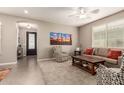 Inviting living room featuring a ceiling fan and plush carpet at 1078 W Redwood Ave, San Tan Valley, AZ 85140