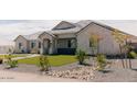 Side view of a lovely single-story home featuring professional landscaping and a well-maintained lawn at 1244 N 106Th Pl, Mesa, AZ 85207