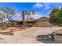 Delightful single-Gathering home boasting desert landscaping, a two-car garage, and a covered front porch at 1403 W Wood Dr, Phoenix, AZ 85029