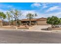 Attractive single story home showcasing xeriscape landscaping, front porch, and a paved driveway at 1403 W Wood Dr, Phoenix, AZ 85029