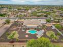 Expansive backyard with pool, covered patio, desert landscaping, and privacy walls in a residential neighborhood at 14539 W Becker Ln, Surprise, AZ 85379