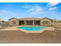 Beautiful private pool with an artistic design, surrounded by a patio and desert landscaping at 14539 W Becker Ln, Surprise, AZ 85379