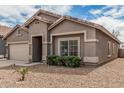 Charming single-story home featuring a two-car garage and a well-maintained front yard at 15829 W Boca Raton Rd, Surprise, AZ 85379