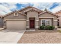 Charming single-story home featuring a two-car garage and a well-maintained front yard at 15829 W Boca Raton Rd, Surprise, AZ 85379