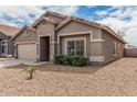 Charming single-story home featuring a two-car garage and a well-maintained front yard at 15829 W Boca Raton Rd, Surprise, AZ 85379
