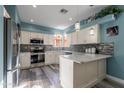 Beautiful kitchen with white cabinets, stainless steel appliances, stylish backsplash, and a breakfast bar at 17216 E Salida Dr # B, Fountain Hills, AZ 85268