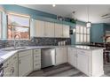Bright kitchen with stainless steel appliances, white cabinets, stylish backsplash, and natural light from the window at 17216 E Salida Dr # B, Fountain Hills, AZ 85268