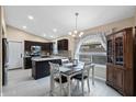 Dining area features modern lighting and is adjacent to the kitchen, complete with a window view at 1770 W Derringer Way, Chandler, AZ 85286