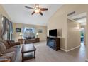 Inviting living room featuring wood floors, neutral paint, ceiling fan and comfortable seating at 1770 W Derringer Way, Chandler, AZ 85286
