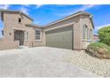 Charming home features desert landscaping, paver driveway, and a two-car garage at 1900 N 140Th Dr, Goodyear, AZ 85395