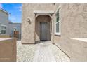 Inviting entryway features a covered porch and a well-maintained walkway with desert landscaping at 1900 N 140Th Dr, Goodyear, AZ 85395