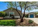 Charming home exterior with desert landscaping and a blue garage door at 23063 W Loma Linda Blvd, Buckeye, AZ 85326