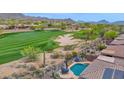 Aerial view of resort style backyard pool area overlooking the golf course and mountains at 2452 W Muirfield Dr, Anthem, AZ 85086