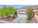 Charming desert home with well-maintained landscaping, a two-car garage, and a welcoming entrance at 2452 W Muirfield Dr, Anthem, AZ 85086