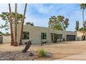 Striking contemporary home with desert landscaping, showcasing its clean lines and modern design at 2517 E Sahuaro Dr, Phoenix, AZ 85028