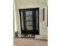 Chic front door with sidelights, features a welcome mat and stylish exterior lighting at 2517 E Sahuaro Dr, Phoenix, AZ 85028