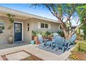 Cozy front porch featuring stylish outdoor seating, a patterned rug, and attractive landscaping at 252 E Orange Dr, Phoenix, AZ 85012