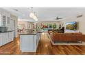 Open-concept living room and kitchen with hardwood floors and a view of the outdoor pool and garden at 252 E Orange Dr, Phoenix, AZ 85012